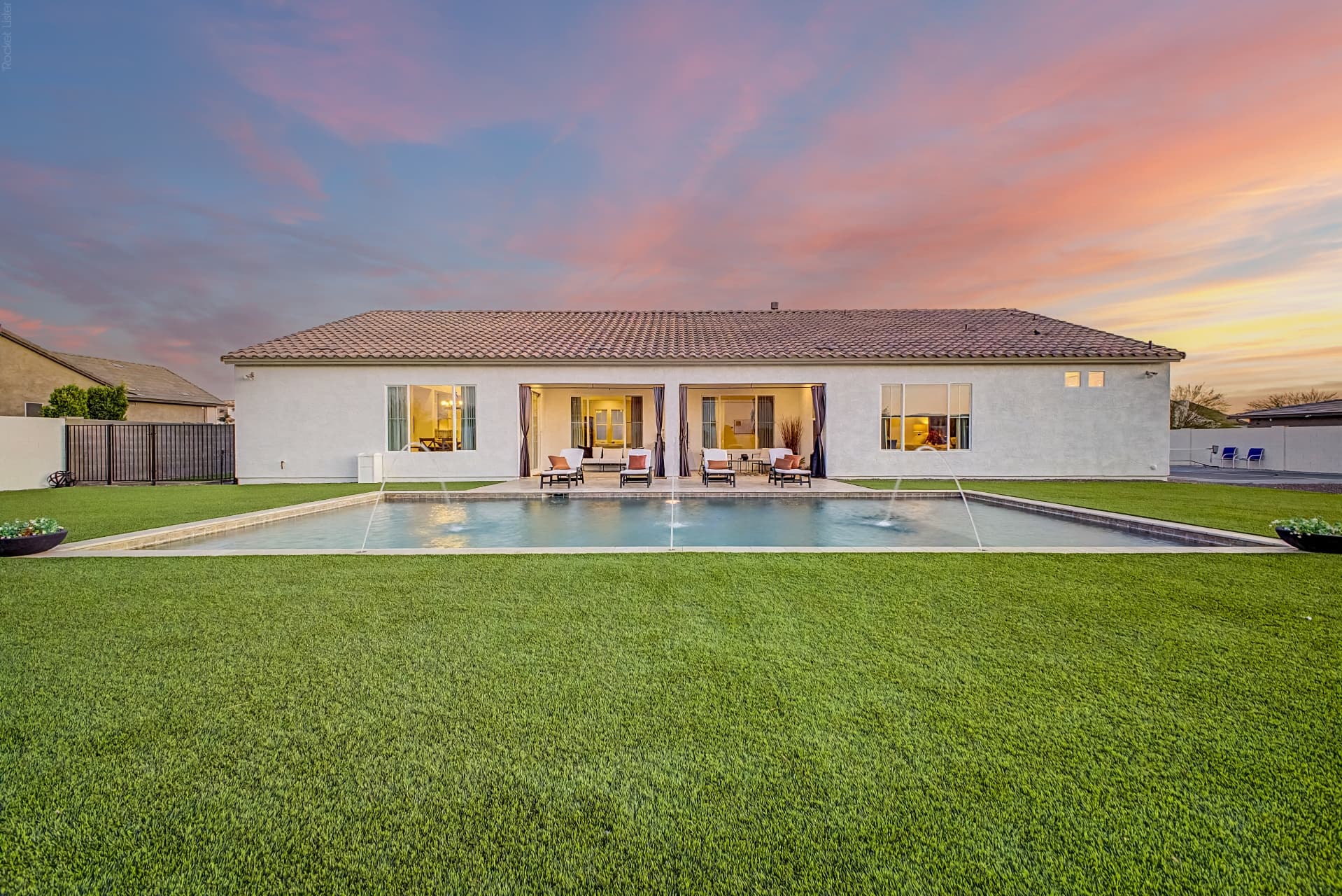 An Arizona luxury home's backyard pool at sunset