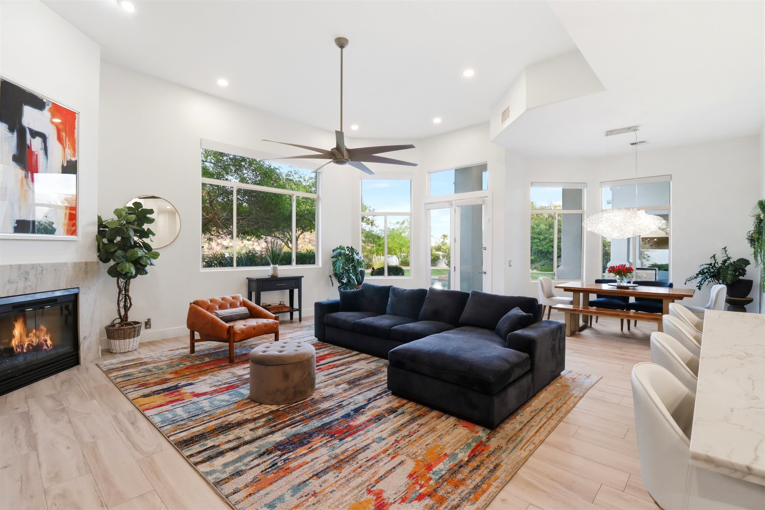 A bright Arizona living room with a lit fireplace